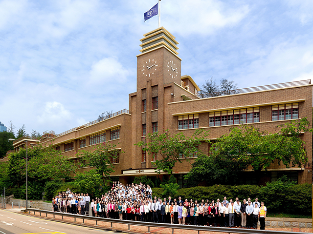 Staff members in front to CLP's Head Office in 2012